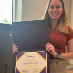 Alyssa Newman with her certificate of nomination for the the Student Employee of the Year Award.